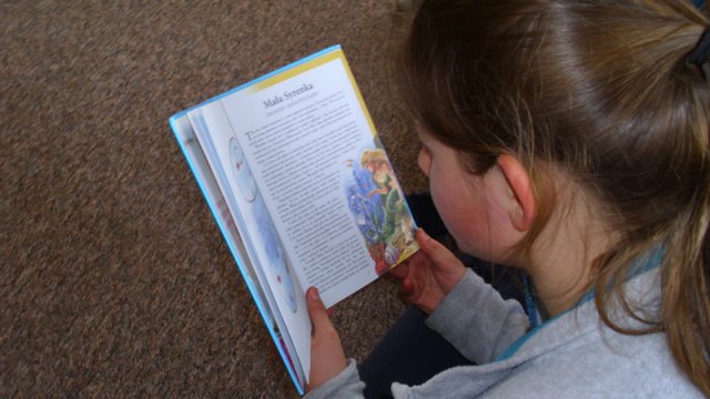  Czwartoklasiści czytają przedszkolakom.